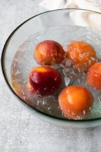 scalded peaches in an ice bath