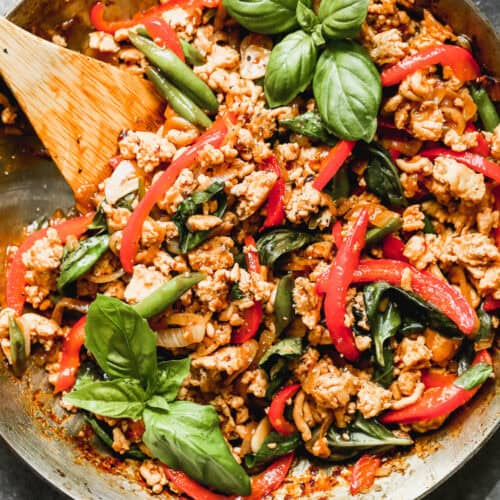 A pan filled with an easy Thai Basil Chicken recipe with ground chicken and fresh vegetables sautéed in a flavorful sauce.