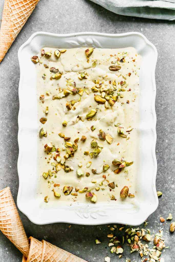 Frozen homemade pistachio ice cream in a rectangle container for serving.