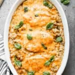 Chicken and rice casserole with melted cheese on top, in an oval serving dish.