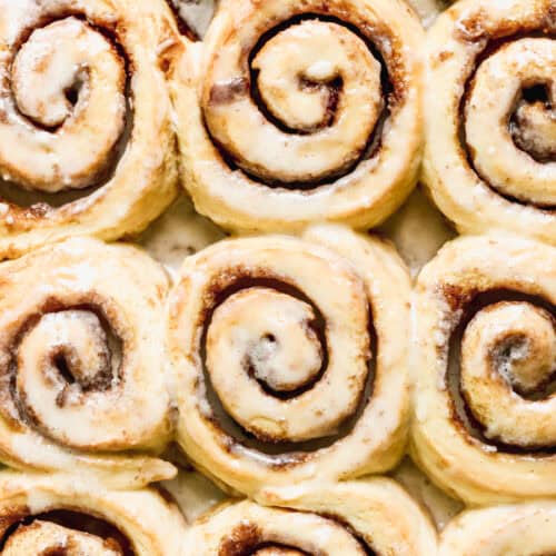 A pan filled with the best cinnamon rolls freshly baked and spread with a delicious glaze. Ready to enjoy!