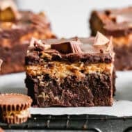 Chocolate Peanut Butter Brownies are the most irresistible dessert with the classic of chocolate and peanut butter done so well! The brownies are fudgy, the peanut butter frosting is creamy, and there are mini reese's cups in every bite!