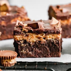 Chocolate Peanut Butter Brownies are the most irresistible dessert with the classic of chocolate and peanut butter done so well! The brownies are fudgy, the peanut butter frosting is creamy, and there are mini reese's cups in every bite!