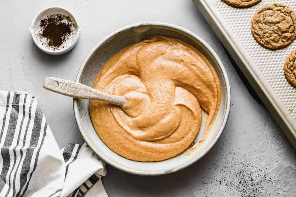 Pumpkin pie dip mixed together in a bowl, with a spoon.