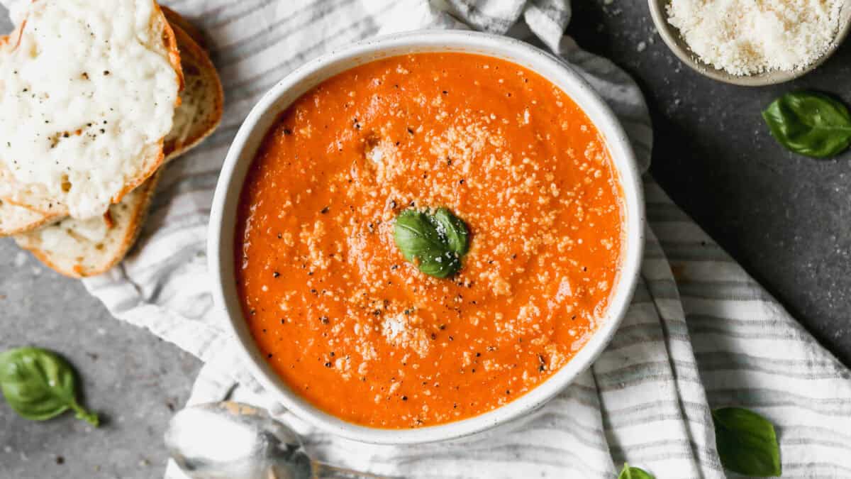 This Roasted Tomato Soup recipe is bursting with flavor and is the perfect soup next to a grilled cheese. It's a copycat of my favorite Panera soup!
