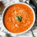 This Roasted Tomato Soup recipe is bursting with flavor and is the perfect soup next to a grilled cheese. It's a copycat of my favorite Panera soup!