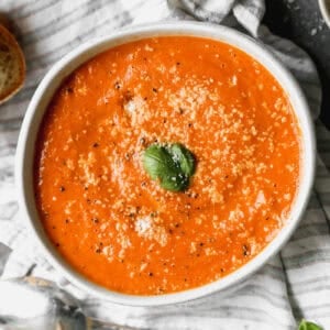 This Roasted Tomato Soup recipe is bursting with flavor and is the perfect soup next to a grilled cheese. It's a copycat of my favorite Panera soup!