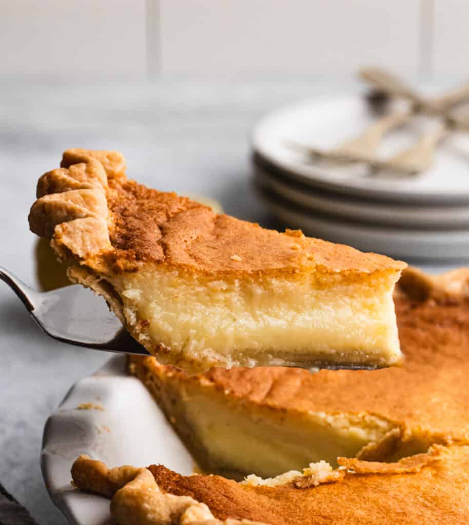 A piece of a lemon chess pie recipe being lifted from the pie plate.