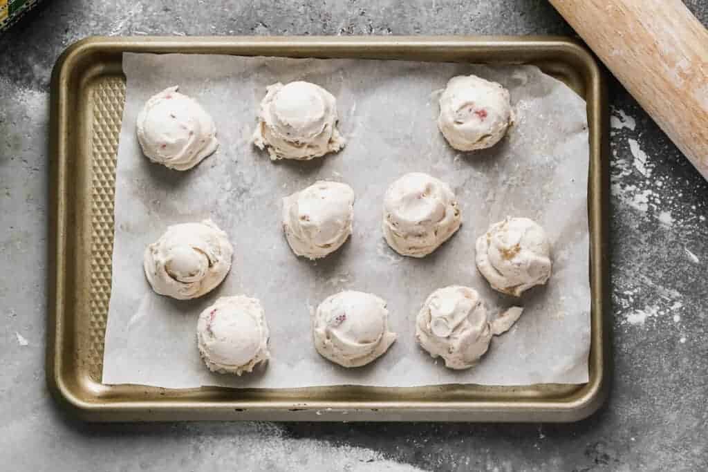 Scooped ice cream balls on a cookie sheet.