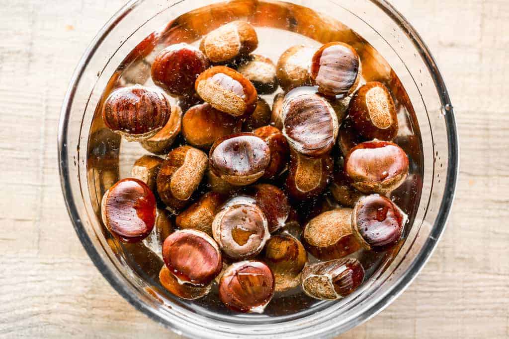 Chestnuts soaking in a bowl of water.