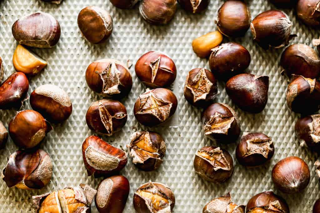 A sheet pan with oven roasted chestnuts on it.