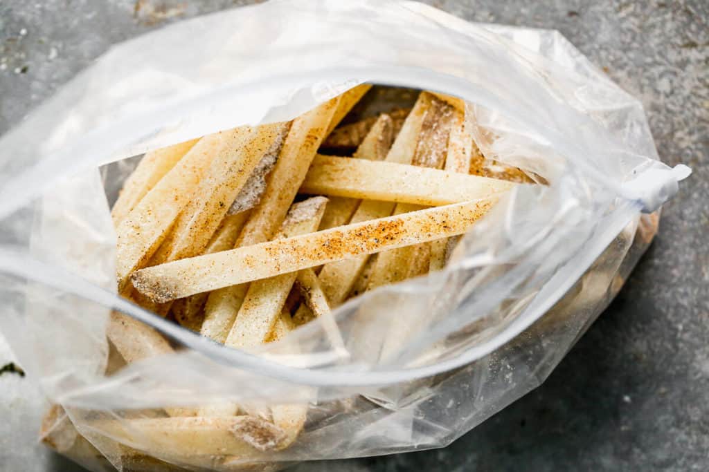 Matchstick potatoes in a ziplock bag with seasoning, to make French Fries.