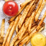 Air Fryer French Fries served on a tray with dipping sauces.