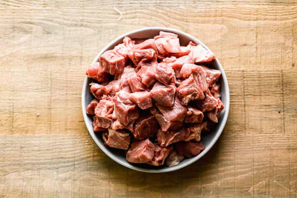 A plate with cubed pork shoulder meat. 
