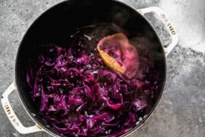Cooked German red cabbage, in a pot, with cooked apple.