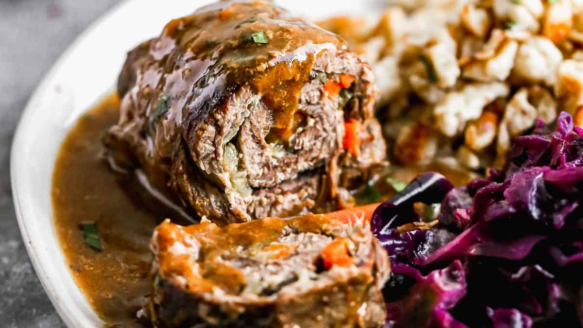 This beef Rouladen recipe is a German staple with mustard, bacon, and veggies wrapped in meat then slow braised until it melts in your mouth. It's perfect for Sunday dinner or any holiday!