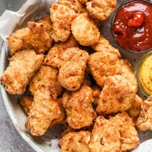 Air Fryer Chicken Nuggets served on a plate with dipping sauce.