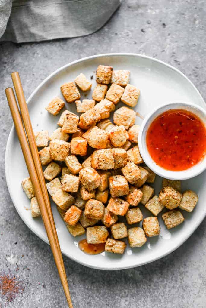 A plate with Air Fryer Tofu and sauce drizzled on top.