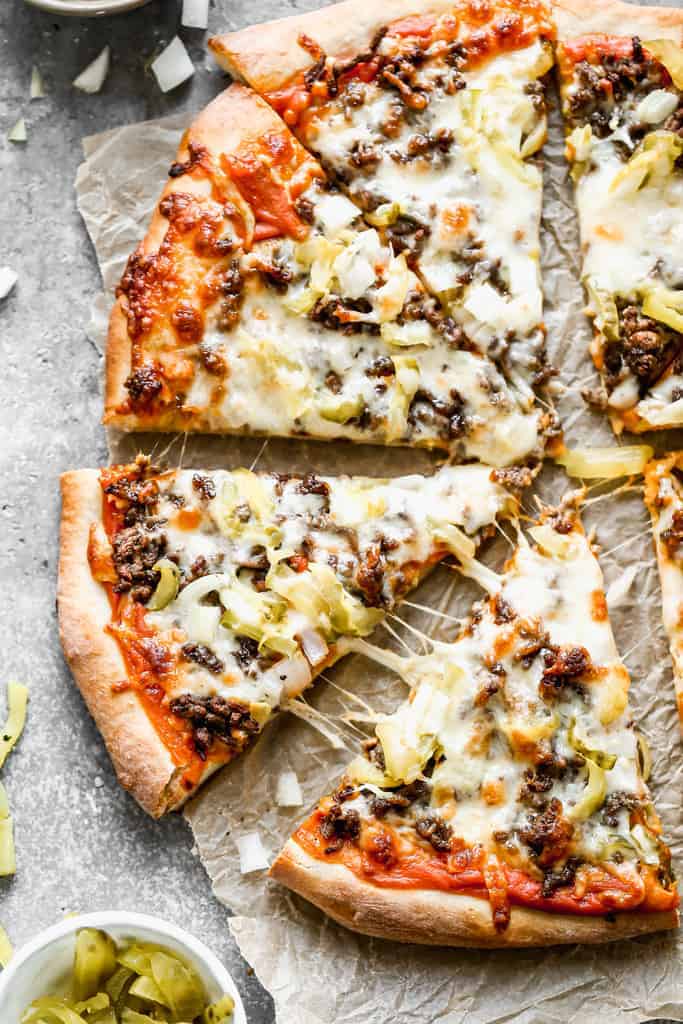 Cheeseburger Pizza baked and cut into slices.