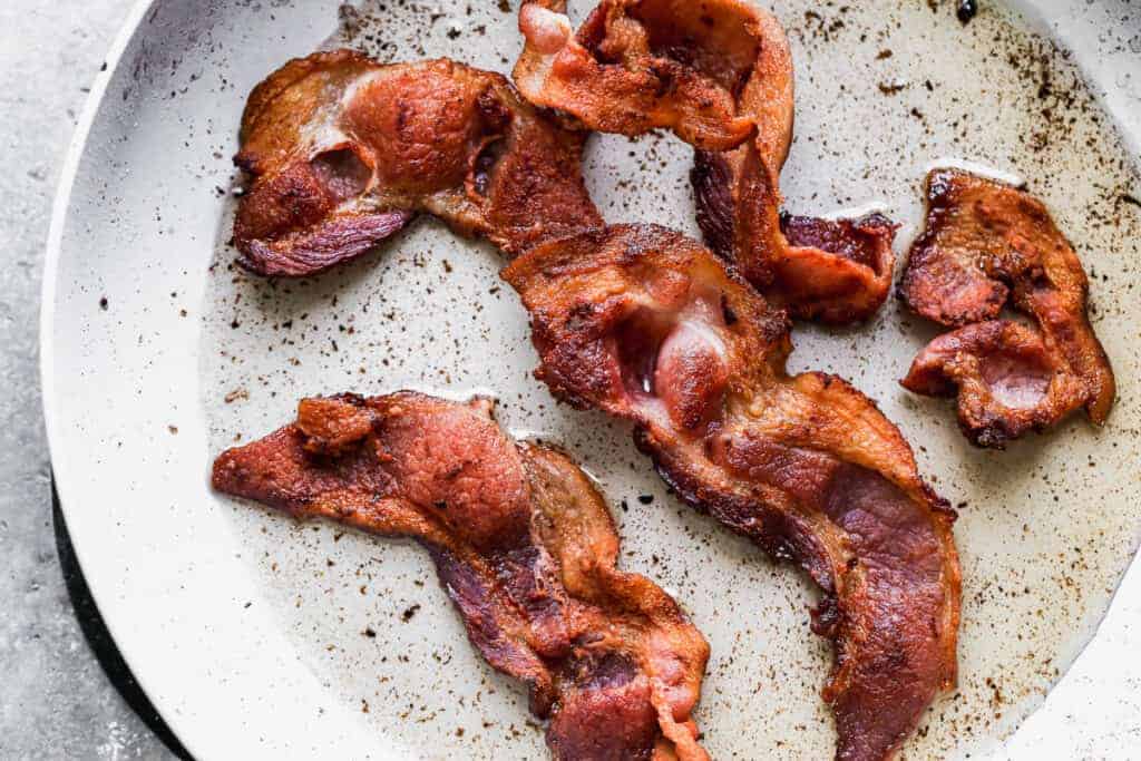 Cooked bacon on a plate.