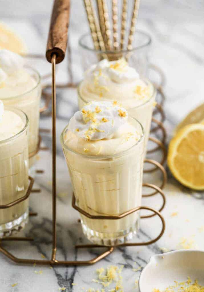 Lemon Mousse served in cups, topped with whipped cream.