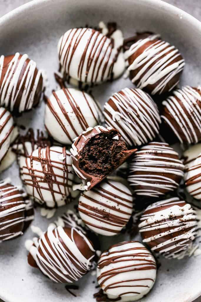 Oreo Balls on a plate with a bite taken from one.