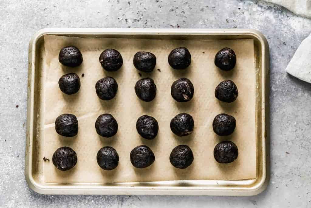 Oreo Balls rolled and placed on a tray.