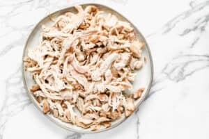 A plate of shredded chicken thigh meat.