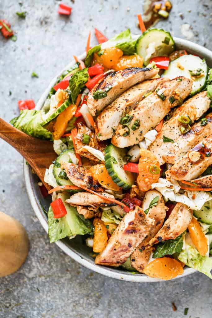 The best Asian Chicken Salad recipe has mandarin oranges, cucumbers, lettuce, carrot, bell peppers, and juicy chicken. We use an easy dressing as the marinade and dressing.