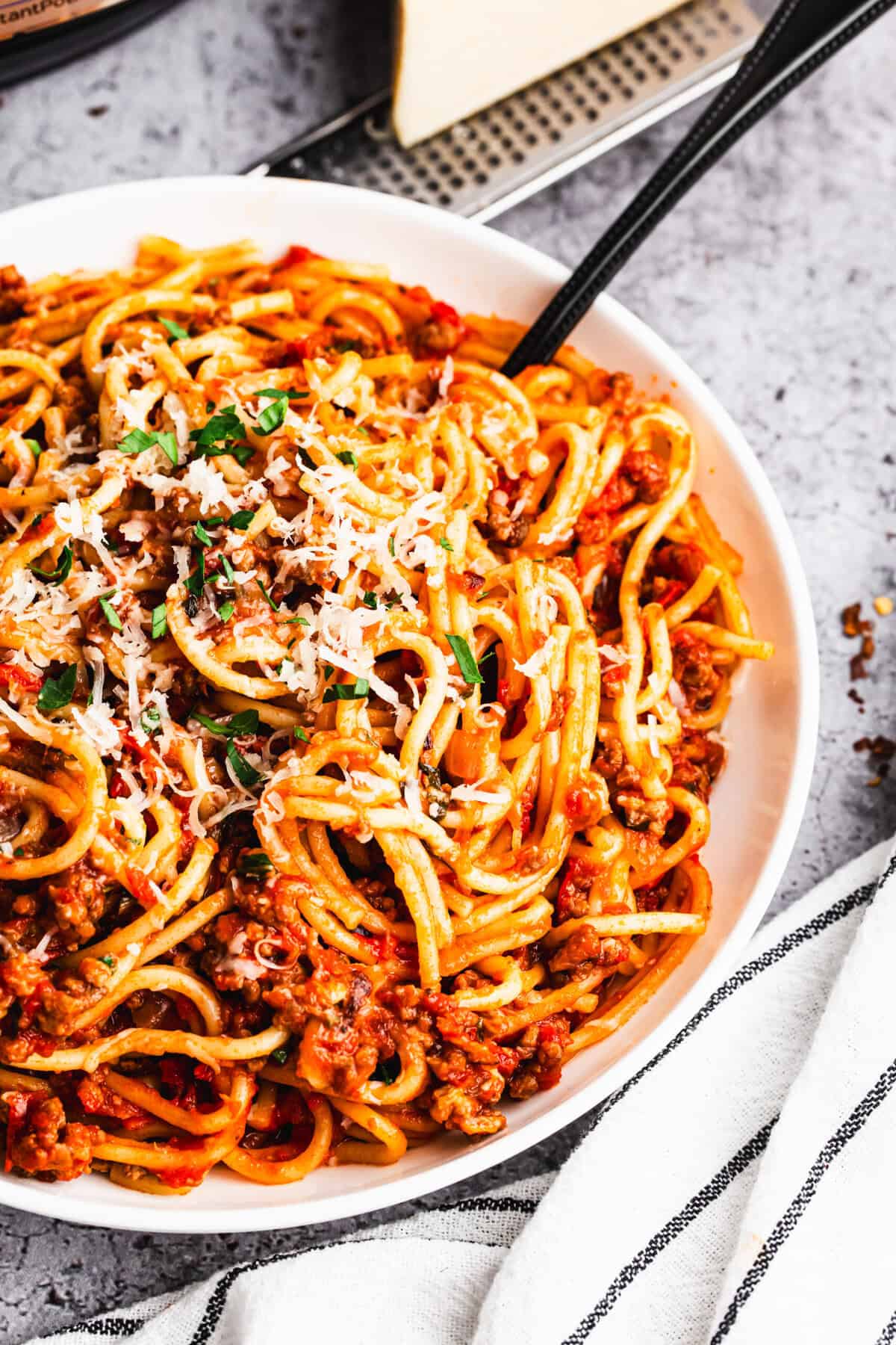 The best Instant Pot Spaghetti has a homemade meat sauce and cooks the noodles perfectly! It's the easiest weeknight meal ready in under 30 minutes!