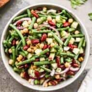 A serving bowl filled with Three Bean Salad made with fresh green beans.