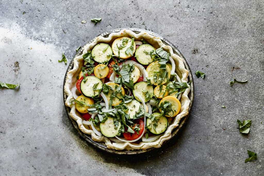 A pie shell filled with sautéed vegetables to make Vegetable Pie.
