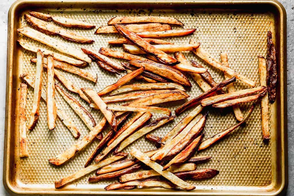 Crispy baked French Fries on a baking sheet.