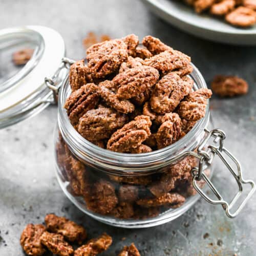 A jar filled with homemade Candied Pecans.