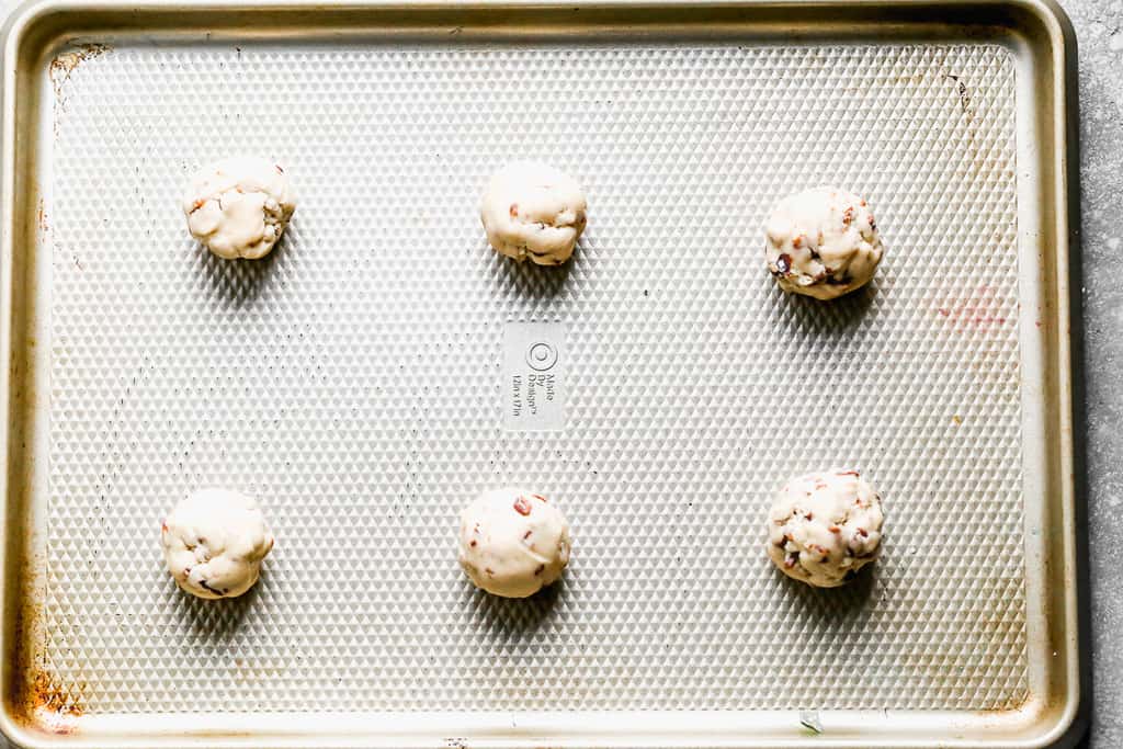 Pecan sandies dough balls on a baking tray.