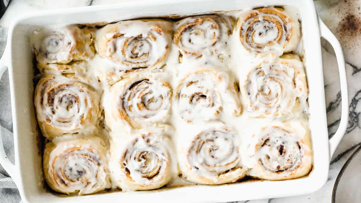 This homemade Overnight Cinnamon Rolls recipe is easy to make the night before and then simply pop in the oven in the morning. They are fluffy, tender, and covered in cream cheese frosting.