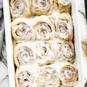 This homemade Overnight Cinnamon Rolls recipe is easy to make the night before and then simply pop in the oven in the morning. They are fluffy, tender, and covered in cream cheese frosting.