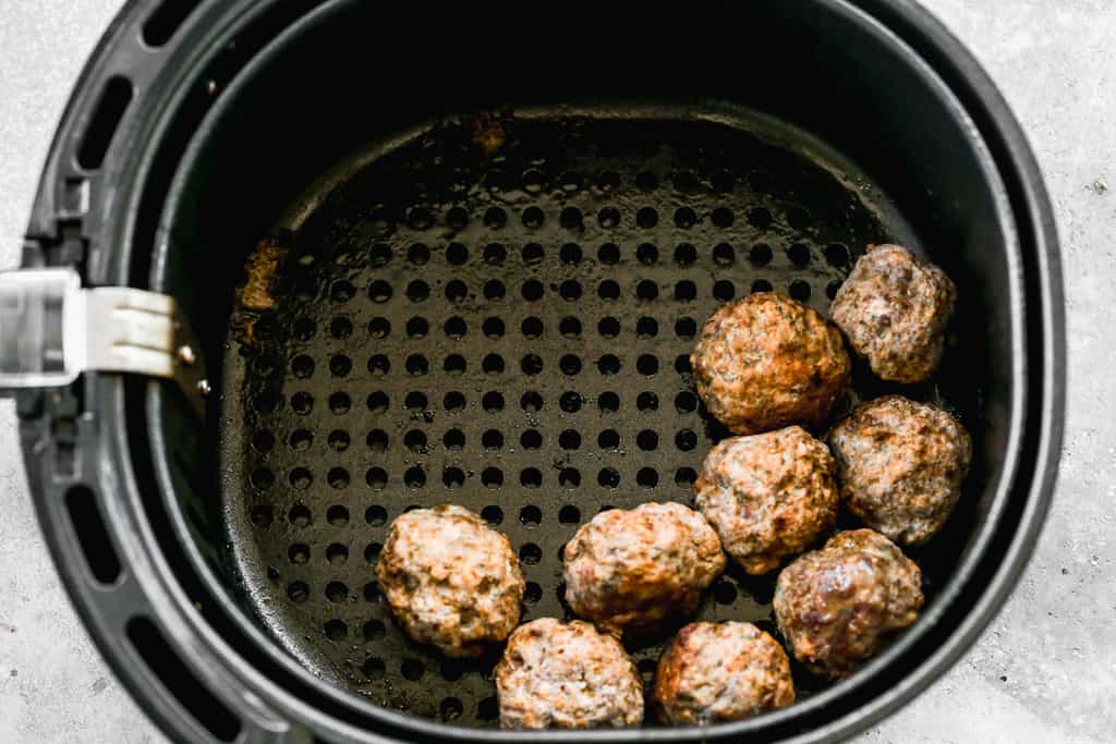 Air fried Meatballs in an airfryer basket.