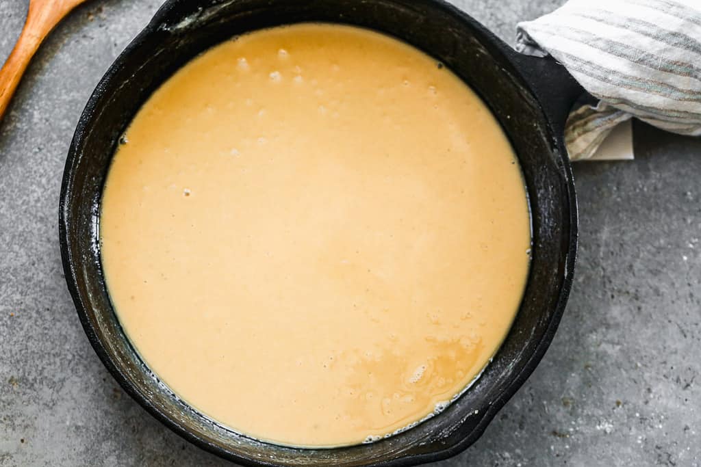 A blonde roux made from flour and fat, cooking in a skillet. 