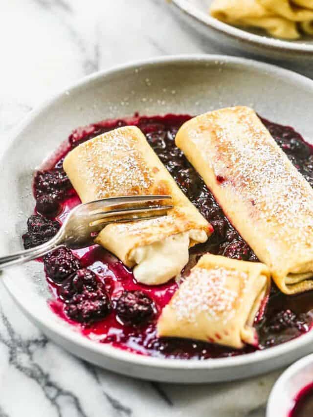 These homemade blueberry blintzes are filled with sweet cheese and fresh berries. They are perfect for a special breakfast, brunch, or dessert.