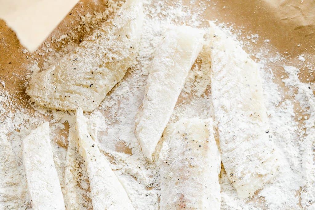 Strips of white fish seasoned with salt and pepper and coated in a thin layer of flour.