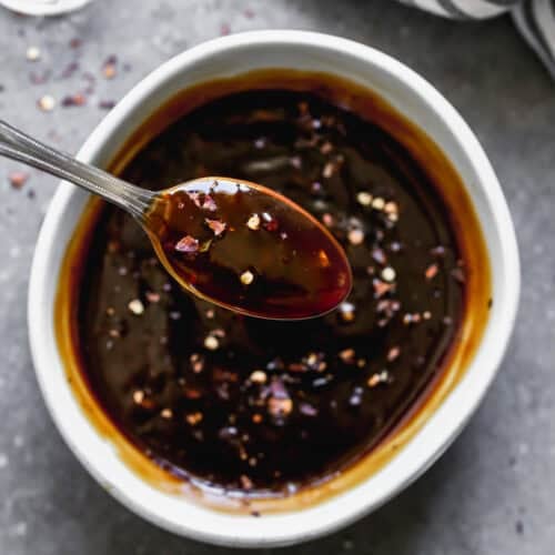 A homemade Teriyaki Sauce recipe in a bowl with a spoon scooping some up.