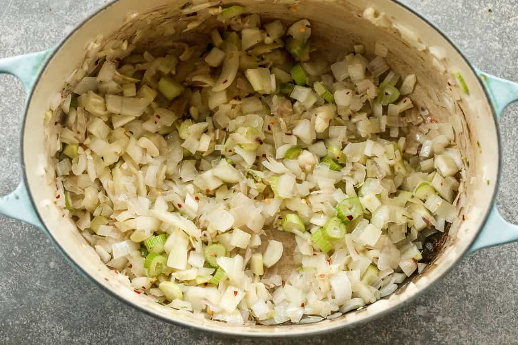 Chopped fennel, onion, shallots and garlic sautéing in olive oil in a large pot.