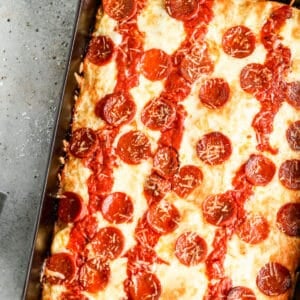 Detroit pizza baked in a steel pan, topped with cheese, sauce and pepperoni.