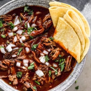 The best Mexican Beef Birria recipe has a rich and flavorful broth and fall-apart tender meat. It's absolutely delicious!