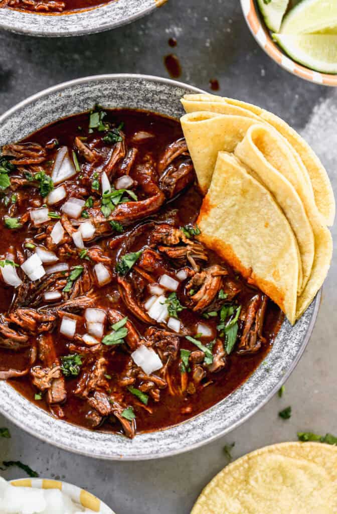 The best Mexican Beef Birria recipe has a rich and flavorful broth and fall-apart tender meat. It's absolutely delicious!