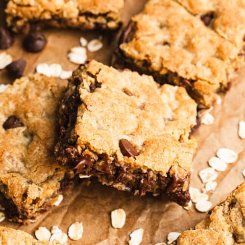 Homemade Oatmeal Chocolate Chip Bars cut into squares on parchment paper, ready to enjoy.
