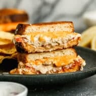 This classic Tuna Melt recipe has high quality tuna seasoned and mixed with mayo and layered with cheese and tomato and cooked until the cheese is melty and the bread is crispy.