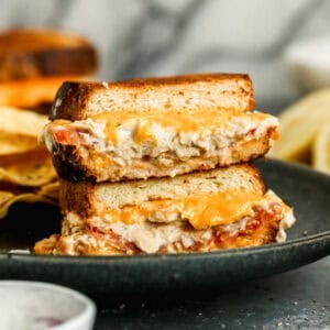 This classic Tuna Melt recipe has high quality tuna seasoned and mixed with mayo and layered with cheese and tomato and cooked until the cheese is melty and the bread is crispy.