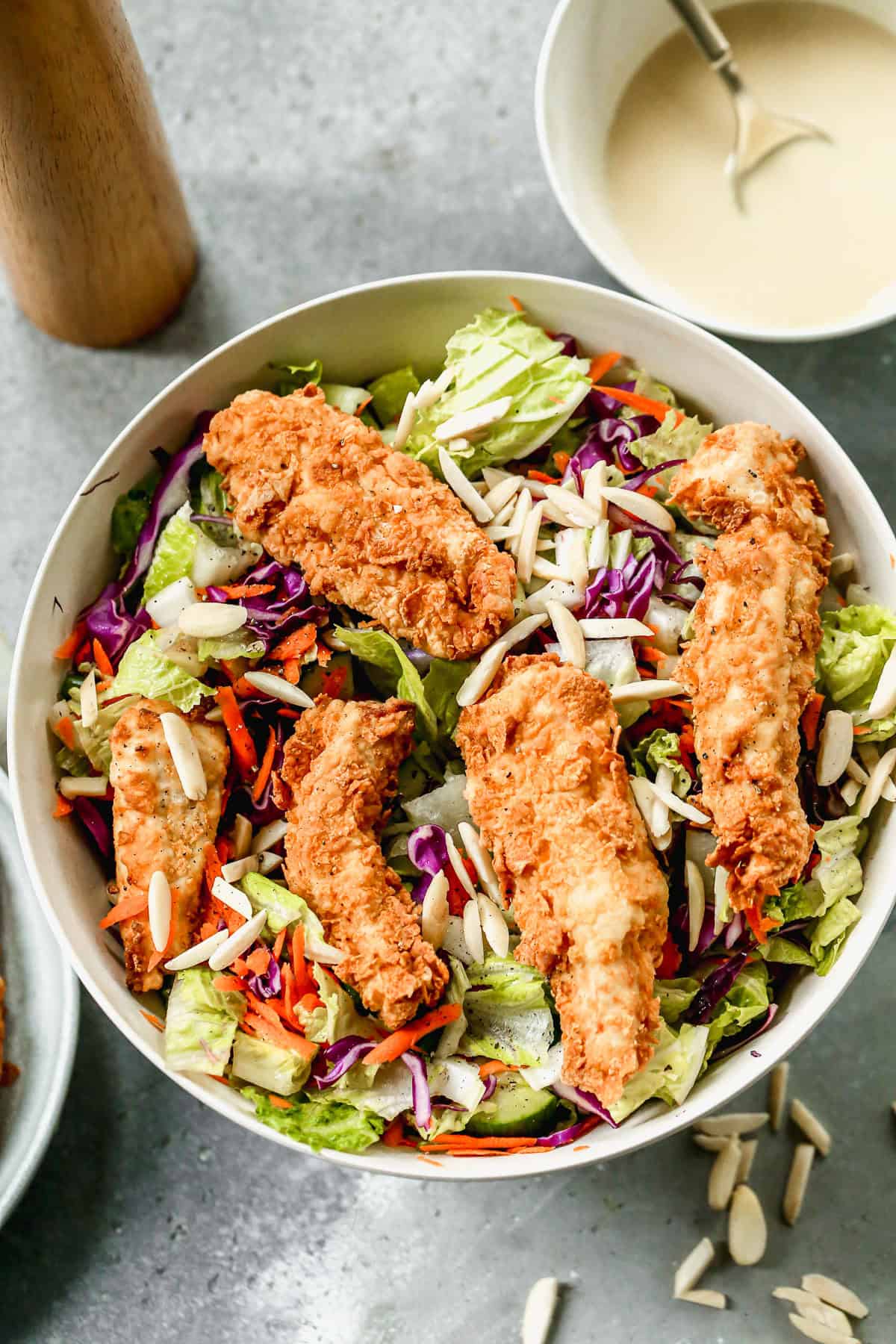 This Applebees Salad recipe has crispy fried chicken on top of lettuce and cabbage and drizzled with the best dressing. It's easy to make and ready in about 30 minutes!